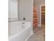 Bright bathroom featuring a bathtub, large window, and walk-in closet at 5540 Indigo Fields Blvd, North Charleston, SC 29418