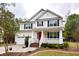 Charming two-story home with a welcoming front porch, red door and well-maintained landscaping at 5540 Indigo Fields Blvd, North Charleston, SC 29418