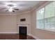 Cozy living room with a fireplace, neutral walls, crown molding, and a large window at 5540 Indigo Fields Blvd, North Charleston, SC 29418