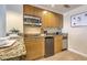 This kitchenette has wooden cabinets, granite countertops, a stainless microwave, and a mini-fridge at 5802 Palmetto Dr # B314, Isle of Palms, SC 29451