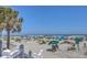 Relaxing view of the beach with palm trees, blue skies, and beach umbrellas at 5802 Palmetto Dr # B314, Isle of Palms, SC 29451