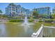 Scenic view of a building complex overlooking a pond with a fountain at 5802 Palmetto Dr # B314, Isle of Palms, SC 29451