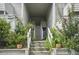 Exterior stairway leading to upper-level residences, surrounded by lush greenery at 607 Greencastle Dr, Goose Creek, SC 29445