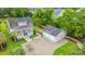 Aerial view showcasing the home's layout, featuring a front porch, a detached garage, and lush greenery at 619 Thomas Glenn Ct, Charleston, SC 29412