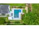 Aerial view of a home's backyard featuring a pool, putting green, patio, and tropical landscaping at 619 Thomas Glenn Ct, Charleston, SC 29412