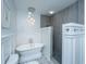 Modern bathroom with freestanding tub, gray tiled shower, and decorative lighting at 619 Thomas Glenn Ct, Charleston, SC 29412