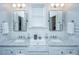 Bright bathroom with dual sinks, marble countertop, white cabinets, and modern fixtures at 619 Thomas Glenn Ct, Charleston, SC 29412