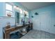 Bright bathroom with double sinks, custom wooden vanity, nautical decorations, and tiled floor at 619 Thomas Glenn Ct, Charleston, SC 29412