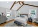 Bright bedroom with vaulted ceiling, exposed beams, light gray walls, and neutral decor at 619 Thomas Glenn Ct, Charleston, SC 29412