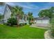 Attractive exterior featuring a front porch, a detached garage, and a well-maintained lawn at 619 Thomas Glenn Ct, Charleston, SC 29412