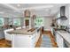 Modern kitchen featuring a spacious island, stainless steel appliances, and ample natural light; perfect for cooking and entertaining at 619 Thomas Glenn Ct, Charleston, SC 29412