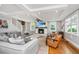 Bright living room featuring a fireplace, neutral sectional, and coffered ceiling offering ample natural light and comfortable seating at 619 Thomas Glenn Ct, Charleston, SC 29412
