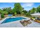 Inviting backyard pool area with lounge chairs, seating, and lush landscaping for outdoor relaxation at 619 Thomas Glenn Ct, Charleston, SC 29412