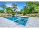 Beautiful backyard pool with spa, poolside umbrella, and well-manicured landscaping at 619 Thomas Glenn Ct, Charleston, SC 29412