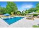 Beautiful backyard pool with spa, poolside umbrella, and well-manicured landscaping at 619 Thomas Glenn Ct, Charleston, SC 29412