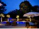Backyard pool and patio area with in-pool chairs, umbrellas, and lounge seating creates an ideal setting at 619 Thomas Glenn Ct, Charleston, SC 29412