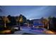 Inviting backyard pool with palm trees, lounge chairs, and ambient lighting creates a perfect nighttime retreat at 619 Thomas Glenn Ct, Charleston, SC 29412