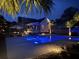 Backyard pool at night featuring ambient lighting, tropical foliage, and an inviting outdoor oasis at 619 Thomas Glenn Ct, Charleston, SC 29412
