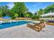 Inviting backyard pool area with lounge chairs, seating, and lush landscaping for outdoor relaxation at 619 Thomas Glenn Ct, Charleston, SC 29412
