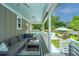 Outdoor porch with a sectional sofa, coffee table, and a view of the pool and backyard at 619 Thomas Glenn Ct, Charleston, SC 29412