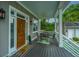 Comfortable front porch with a ceiling fan, a rustic wood door, and a charming seating area at 619 Thomas Glenn Ct, Charleston, SC 29412