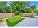 Lush backyard putting green with landscaped borders and stone pavers at 619 Thomas Glenn Ct, Charleston, SC 29412