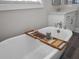 Soaking tub with wooden tray and bathroom essentials near a marble countertop at 637 Lynne Ave, Charleston, SC 29412