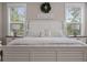 Cozy bedroom with a decorative wreath, wooden floors, and matching nightstands at 637 Lynne Ave, Charleston, SC 29412