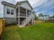 Two-story home featuring a backyard with stairs leading to a balcony and a well-maintained lawn at 637 Lynne Ave, Charleston, SC 29412