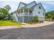 A two story home featuring lush yard, covered porch, and driveway at 637 Lynne Ave, Charleston, SC 29412
