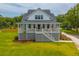 Charming two-story beach house with a welcoming front porch and staircase at 637 Lynne Ave, Charleston, SC 29412