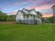 Two story home featuring a spacious lawn and elevated porch at 637 Lynne Ave, Charleston, SC 29412