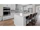 Bright kitchen features a large island with bar seating, stainless steel appliances, and stylish white cabinetry at 637 Lynne Ave, Charleston, SC 29412