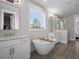 Bright and airy main bathroom with standalone tub and dual vanities at 637 Lynne Ave, Charleston, SC 29412