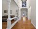 A living room has hardwood floors and a high, arched ceiling with white columns and natural light throughout at 6385 Shilelagh Oaks Pkwy, Ravenel, SC 29470