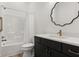 Modern bathroom featuring a bathtub, toilet, and custom vanity with quartz countertop at 703 Blueway Ave, Summerville, SC 29486