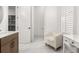Well-lit bathroom features a vanity area, marble floors, and a white chair at 703 Blueway Ave, Summerville, SC 29486