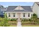 Inviting single-story home with a classic front porch, white columns, rocking chairs, and manicured landscaping at 703 Blueway Ave, Summerville, SC 29486