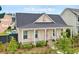 Charming single-story home featuring a welcoming front porch, pink front door, and lush landscaping at 703 Blueway Ave, Summerville, SC 29486