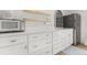 Bright kitchen features white cabinets, quartz counters, stainless appliances and lots of storage space at 703 Blueway Ave, Summerville, SC 29486