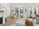 Bright and airy living room with a fireplace, large windows, and hardwood flooring at 703 Blueway Ave, Summerville, SC 29486