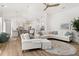 Bright living area with hardwood floors, contemporary furniture, and an open layout to the kitchen at 703 Blueway Ave, Summerville, SC 29486