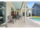 Covered patio with comfortable seating, outdoor dining area and beautiful views of the backyard pool at 703 Blueway Ave, Summerville, SC 29486