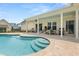 Inviting pool with a tanning ledge and built-in steps, with a covered porch and outdoor seating at 703 Blueway Ave, Summerville, SC 29486