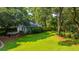 Sprawling backyard with an outbuilding, mature trees, and vibrant green lawn at 802 Robert E. Lee Blvd, Charleston, SC 29412
