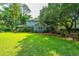 Spacious backyard with mature trees, manicured lawn and established landscaping at 802 Robert E. Lee Blvd, Charleston, SC 29412
