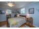 Comfortable bedroom with a ceiling fan, two windows, stylish furnishings, and beautiful hardwood flooring at 802 Robert E. Lee Blvd, Charleston, SC 29412
