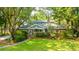 Charming two-story brick home with lush landscaping and mature trees at 802 Robert E. Lee Blvd, Charleston, SC 29412