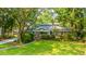 A single-Gathering home with a brick facade, well-manicured lawn, and mature trees at 802 Robert E. Lee Blvd, Charleston, SC 29412