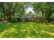Landscaped front yard with lush lawn and beautiful trees at 802 Robert E. Lee Blvd, Charleston, SC 29412